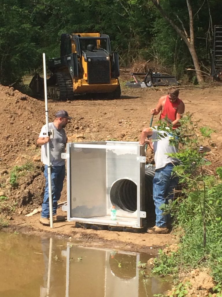 Men building a water control structure